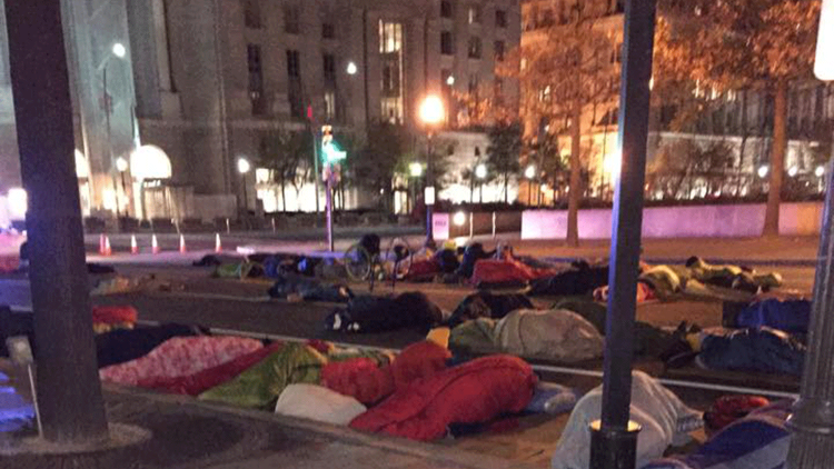 A “Sleep Out” in Washington, D.C.’s Freedom Plaza during Hunger & Homelessness Awareness Week in mid-November. Photo Credit: Laura Tarnosky, <a href="http://streetsense.org/article/covenant-house-advocates-freedom-plaza-sleep-out-previews-vigil/#.VlzIkmSrRz9" target="_blank"><span class="s1">Street Sense.</span></a>
