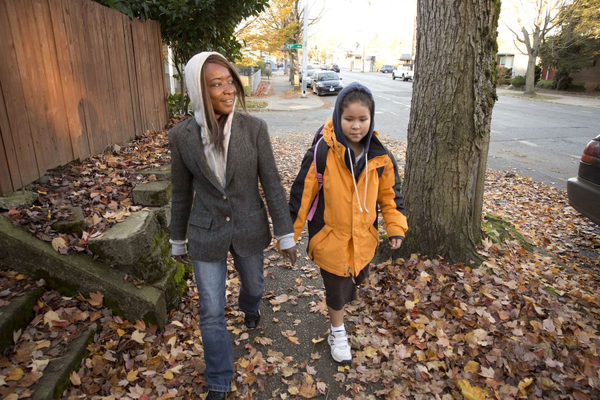 <a href="http://firesteelwa.org/2015/02/we-had-to-tell-her-about-santa-homeless-parents-face-impossible-choices/" target="_blank">Andrea Charles</a> walks her daughter Zoe to school. Thanks to the efforts of Andrea and other advocates, a new law directs resources toward students who are experiencing homelessness. Photo by Dan Lamont.